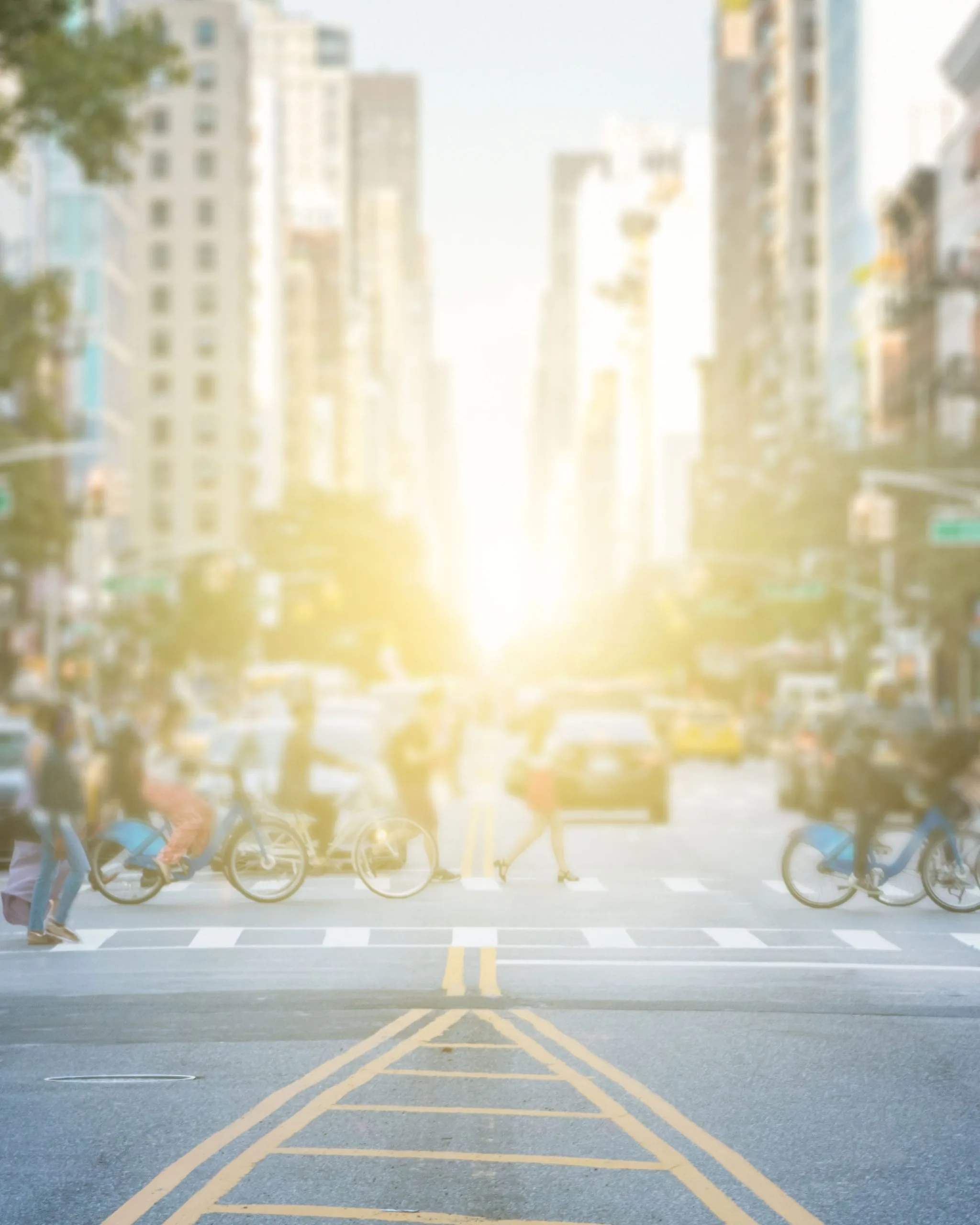 A sunlit New York City street framed by classic buildings